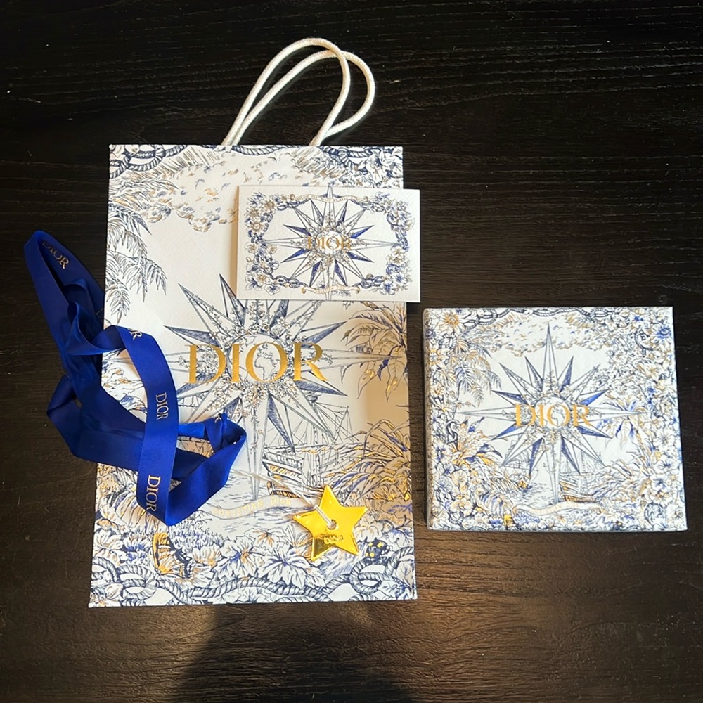 Dior shopping bag, box, ribbon, tassel ornament, and card.
